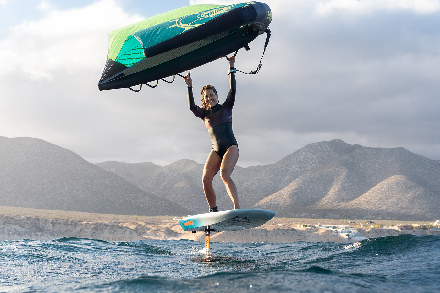 A women windsurfs on a slingshot board