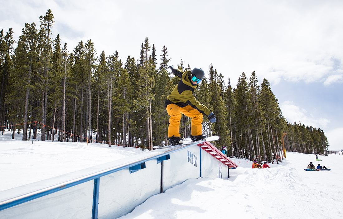 AASI Snowboard Team member slides a rail on his snowboard