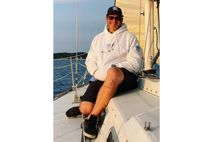 Ron Shepard sits on a sailboat